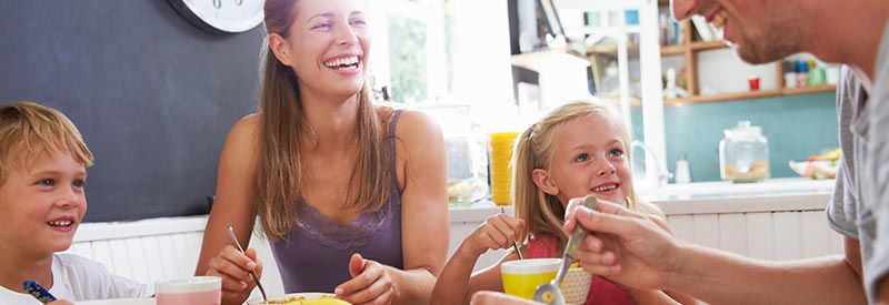 family enjoys breakfast in their new home